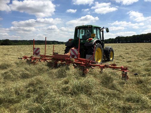 Tractor tending to the Hay in the field